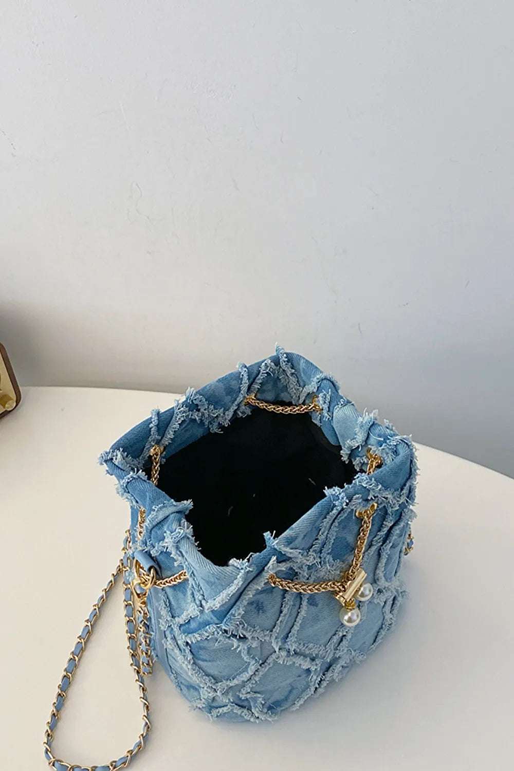 Chain Drawstring Raw Edge Denim Bucket Bag - Crossbody Bag by Trendsi | Available at Handbags Specialist Headquarter