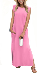 Woman in a pink sleeveless dress, holding a white cup, wearing a sun hat and sandals.