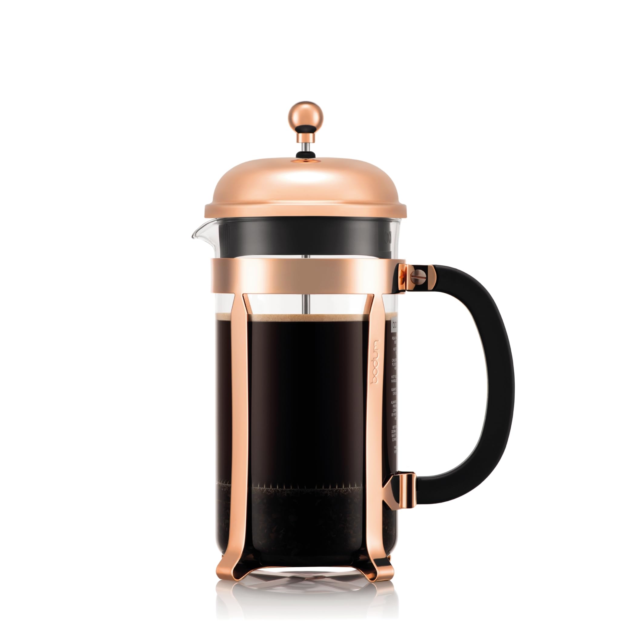 Copper and glass French press with black handle, filled with dark coffee.