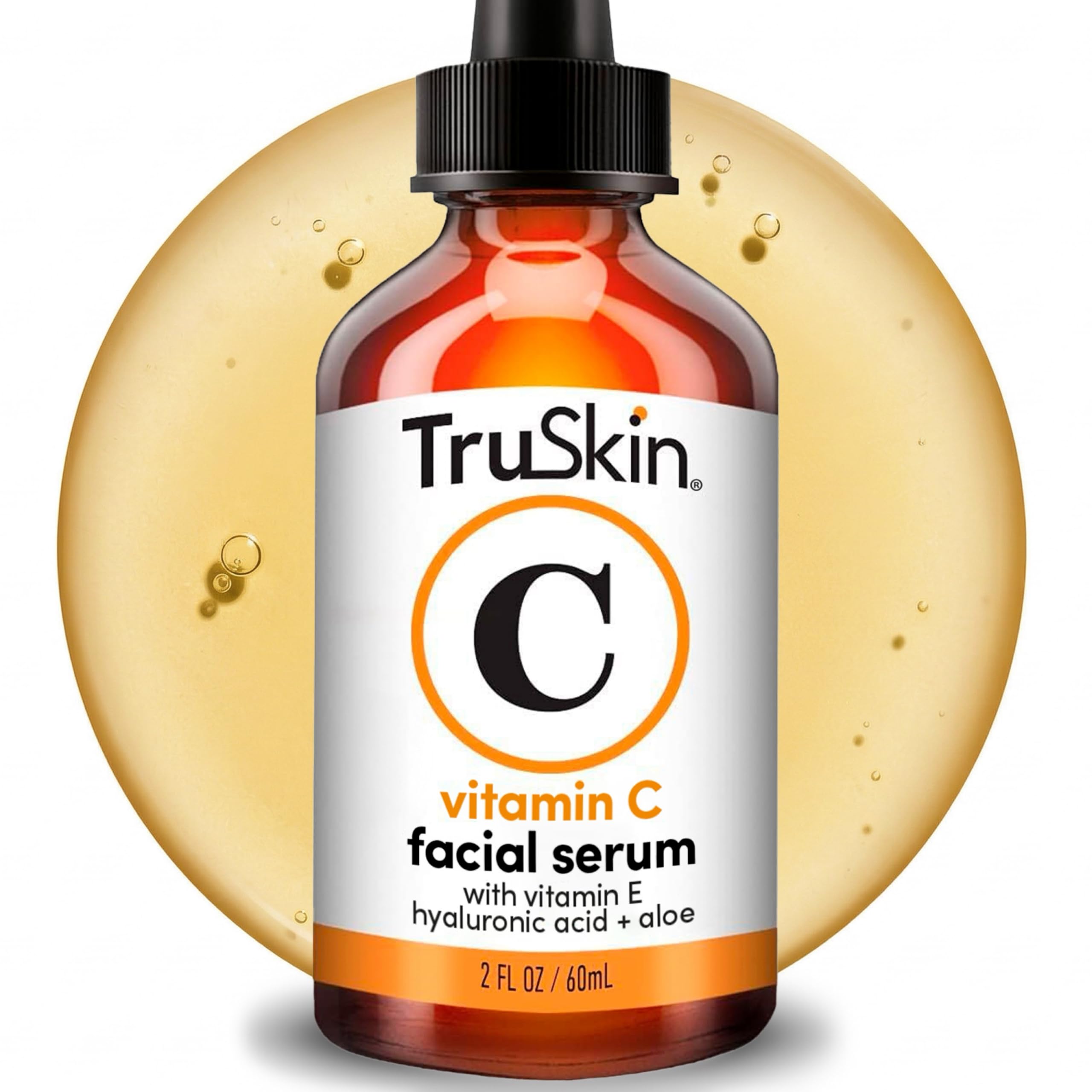 Amber serum bottle with black cap, labeled "Vitamin C," against a backdrop of golden liquid.