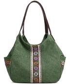 Green fabric tote bag with brown handles and colorful geometric embroidered patterns.