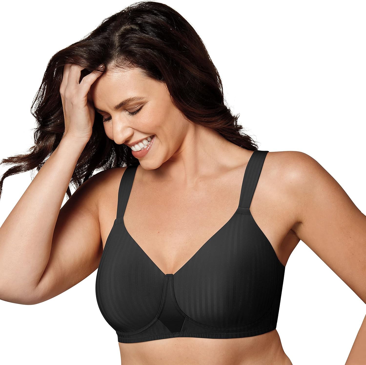 Smiling woman in a black striped bra, touching her hair, against a white background.