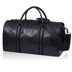 Black leather duffel bag with dual handles, a shoulder strap, and a side zipper pocket.