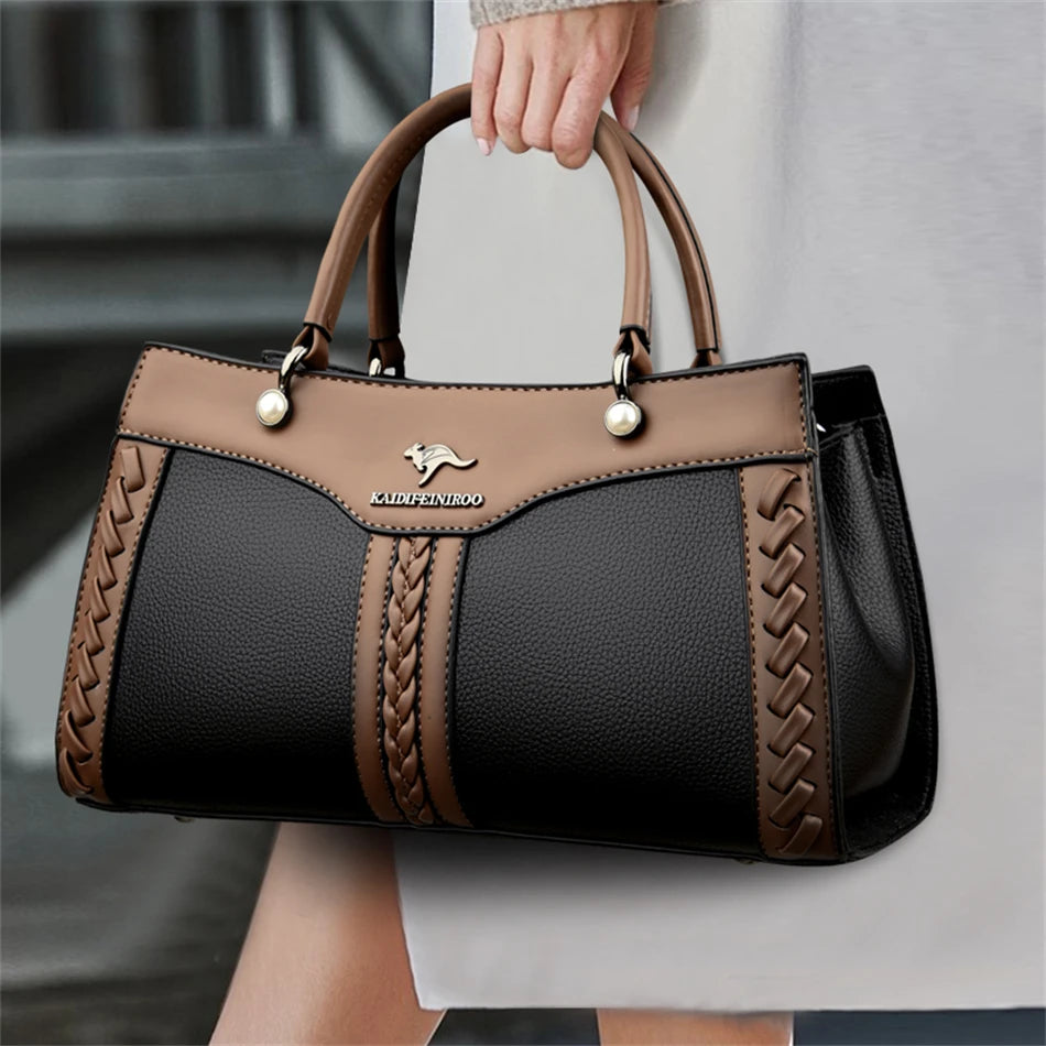 Brown and black handbag with braided details, silver logo, and round handles.