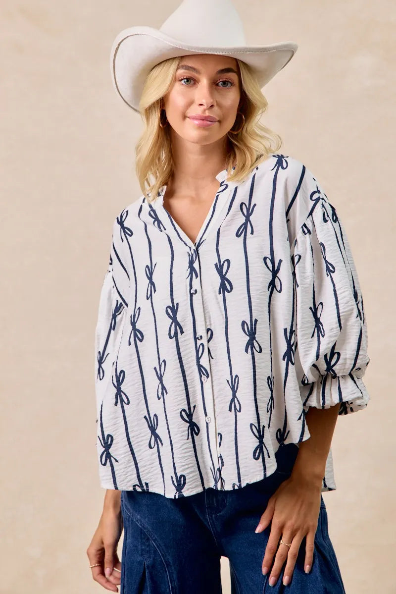 BiBi Bow Ribbon Printed Woven Bubble Sleeves Top - Tops by Trendsi | Available at Handbags Specialist Headquarter